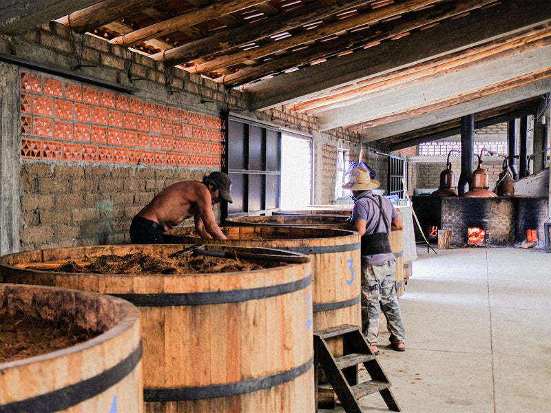 _<h2>Here are fermentation tanks. Note the live fire under the copper pot still in the background</h2>